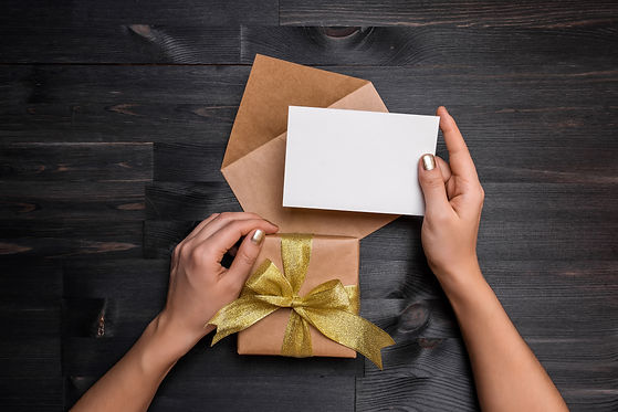 Female hands holding gift card and gift