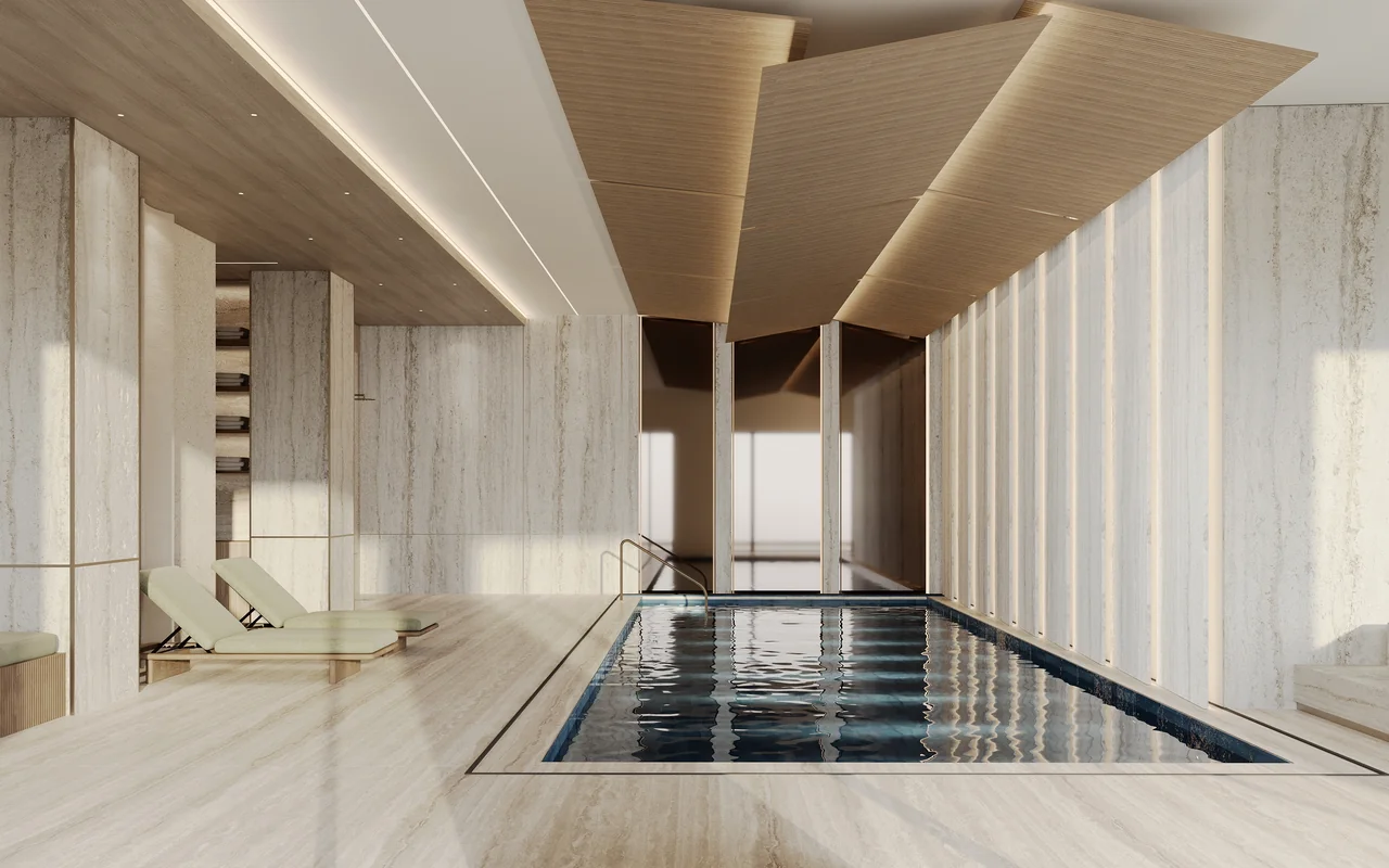Limestone indoor pool design with a timber ceiling, pale stone walls and tall windows.