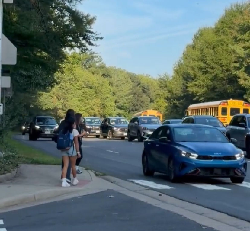 At the South Lakes Drive intersection across from the high school, vehicles continue to pass as student pedestrians attempt to cross. Photo courtesy of Melanie Meren