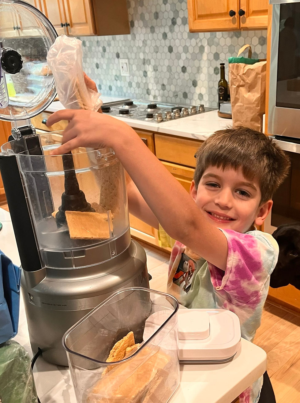 The youngest Estep son making his own cheesecake bowl.