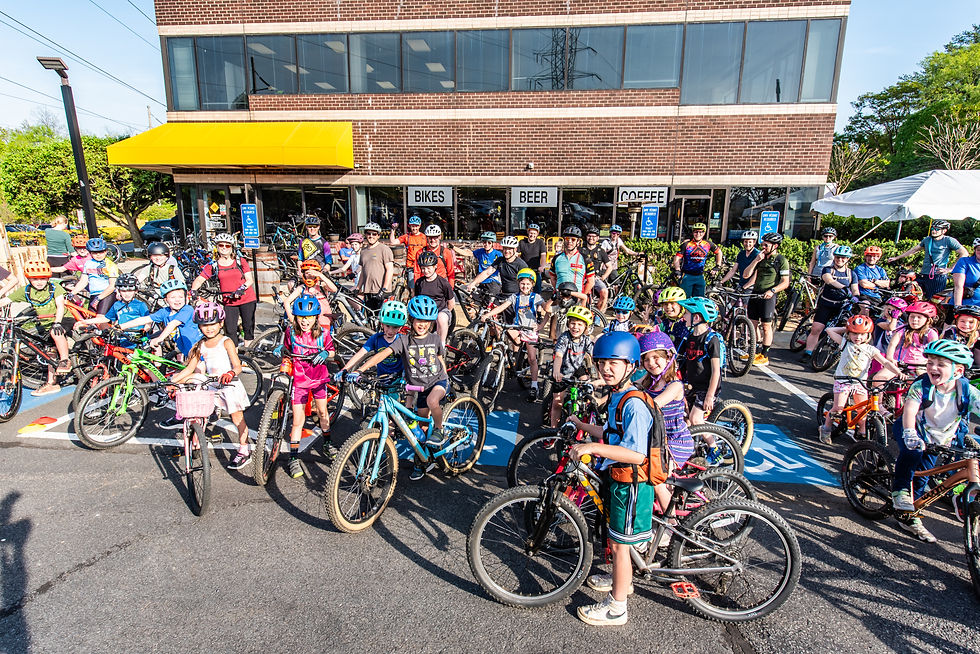 Families gather outside of the Bike Lane in Reston just before their weekly sMOREs ride. Photo by Benjamin Burgess.