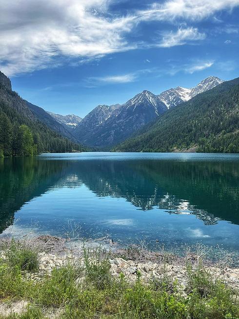 Mountain range reflecting in a clear blue lake.
