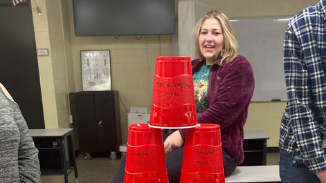 The students used solo cups with problems or accomplishments on them to learn about Maslow's hierarchy of needs.