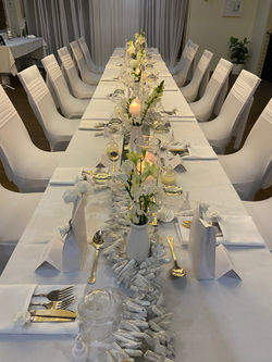 Driftwood with tall clear candles and fresh florals