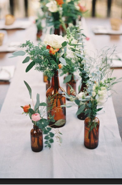 Bottles styled with fresh florals