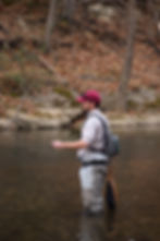 Man fishing in stream