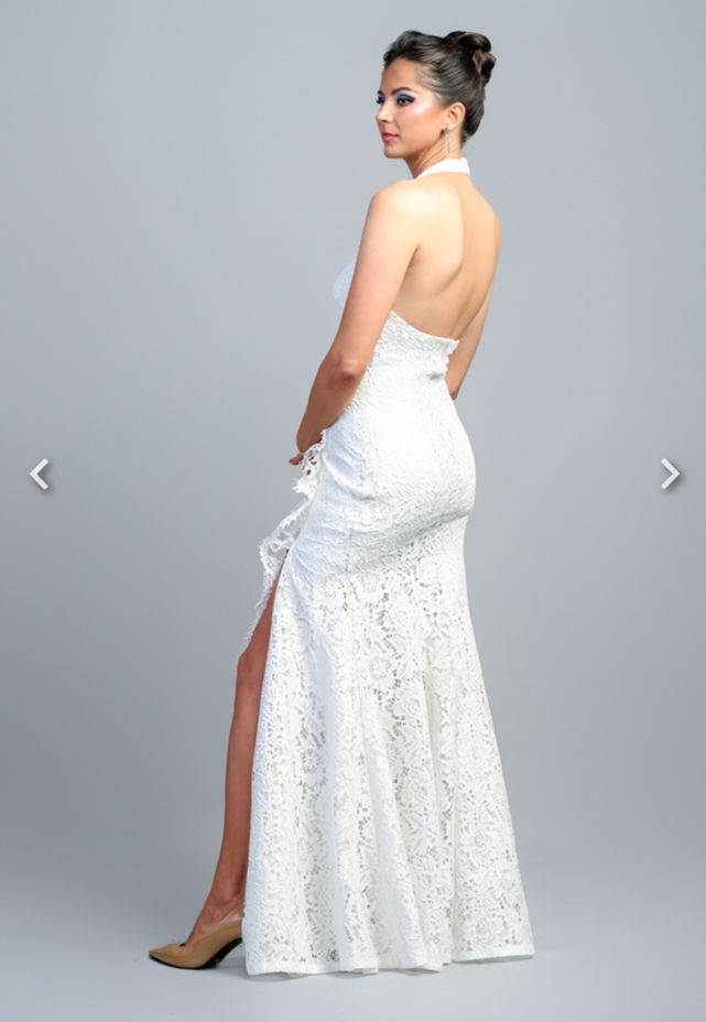 Thumbnail: Woman in white halter dress with side slit, looking back