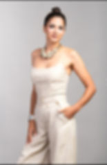 Woman in beige strapless jumpsuit, chunky necklace