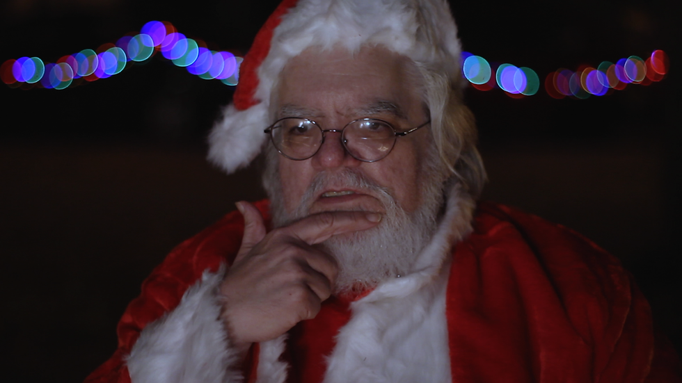 Robert M. Price pays Father Jozef a visit on Christmas Eve dressed as Santa Claus.
