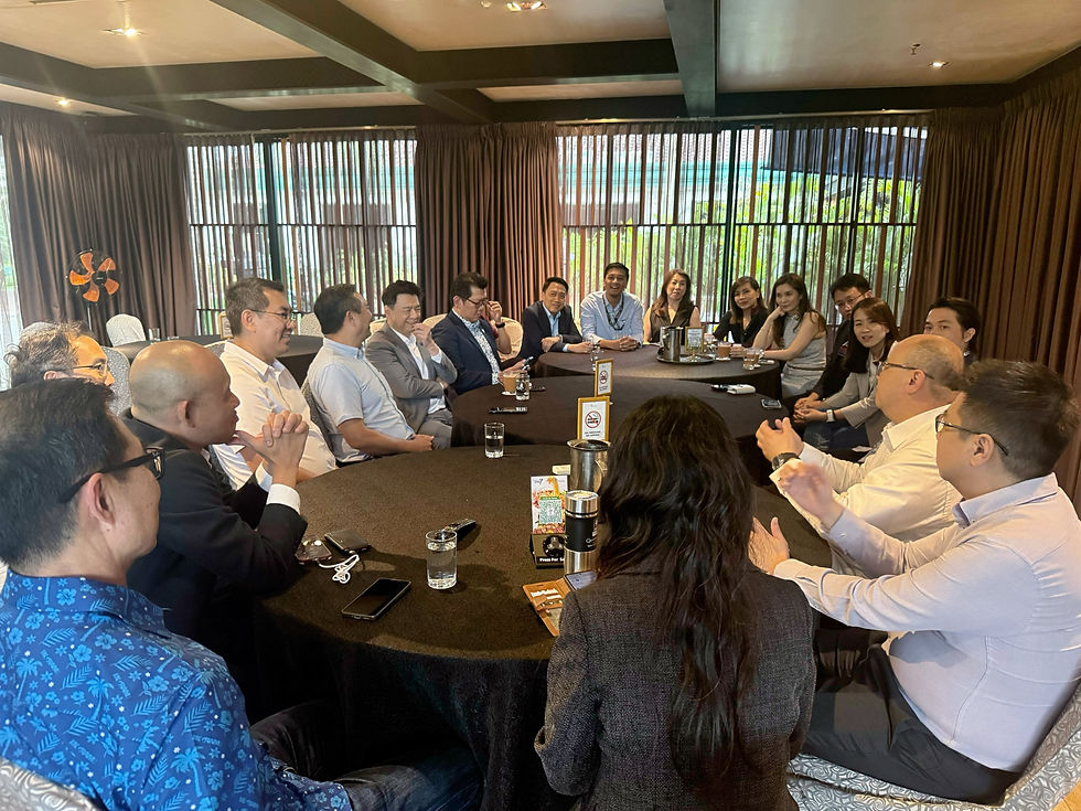 AC2's founder Aw with YB Ng Sze Han and a group of tech industry leaders in business attire sit around a large table, engaged in discussion. The room has curtains and natural light, creating a professional atmosphere.