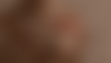 Close-up of a person holding an orange flower. Text reads: When Divine Feminine Spirituality Glorifys Motherhood. Warm, soft lighting.