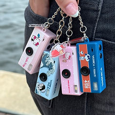 Four FUNtastic Keychain Cameras attached to a side pocket, showcasing its compact design