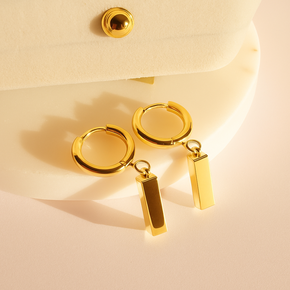 Gold hoop earrings with rectangular bar pendants, featuring a polished minimalist design on a soft neutral background.