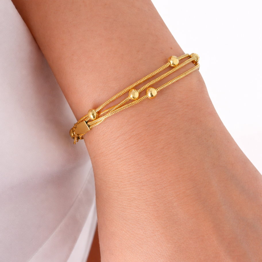 Elegant gold triple-strand bracelet close-up