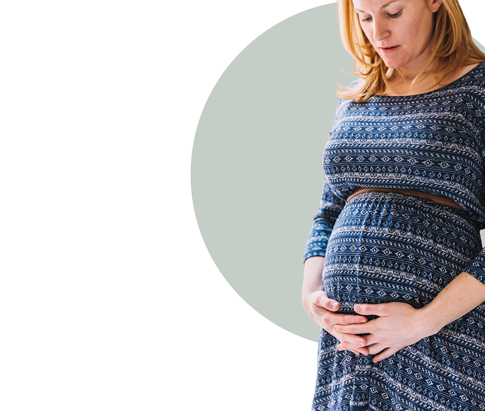 Pregnant woman cradling stomach