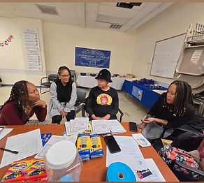 Children and adults participating in a Books Are Treasures Autism Awareness Month activity