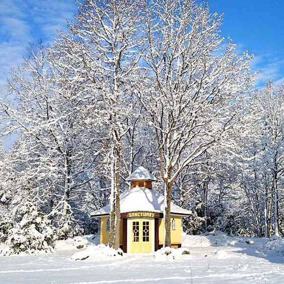 Sanctuary building in winter, with snow and sunshine.