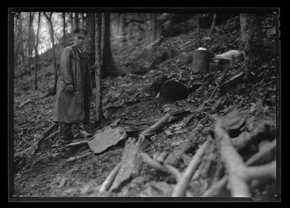 Figure 2. Prohibition agents standing near a confiscated moonshine still in Kentucky. ExploreUK University of Kentucky Libraries.