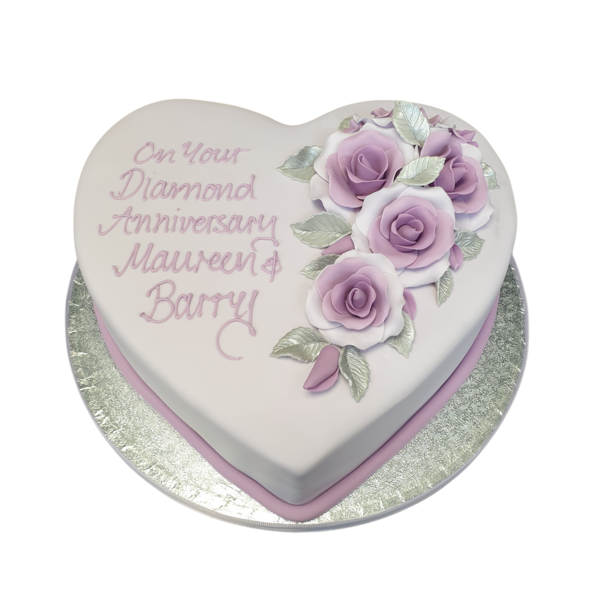 A beautifully decorated heart-shaped cake adorned with delicate roses, perfect for special occasions or celebrations in UK.