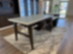 Modern showroom with table, chairs, and Hunter Douglas displays