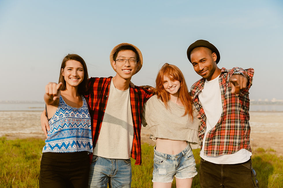 young-multiracial-friends-smiling-while-pointing-f-2022-03-02-18-56-37-utc.jpg