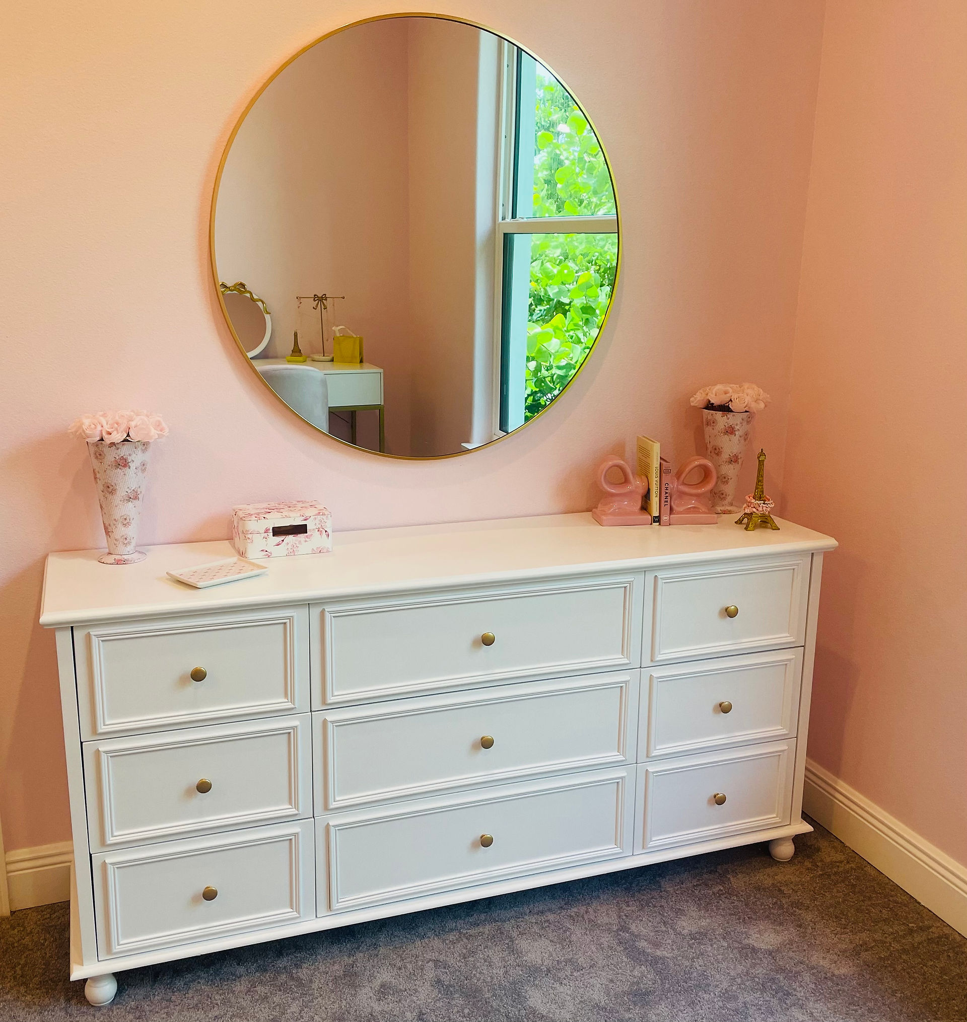 Aesthetic Love Shack Fancy dresser with aesthetic mirror, bow bookends, Louis Vuitton and Chanel book,  and preppy floral arrangements.   