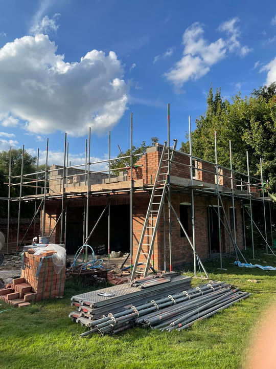 JJP Scaffolding Services Ltd setting up a secure scaffolding structure around a new home build, providing safe access for construction work.