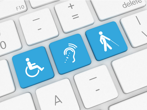 Close-up of a keyboard with three blue keys showing symbols for wheelchair, hearing, and visual impairments, highlighting accessibility.