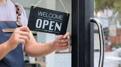 cropped-shot-of-business-owners-hold-an-open-sign-2021-08-27-22-27-54-utc