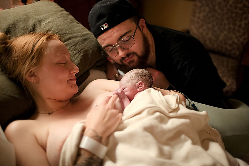 mom and dad with newborn after birth