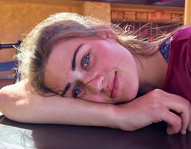 picture of a woman laying with her head on her arm and smiling at the camera sarah chastain