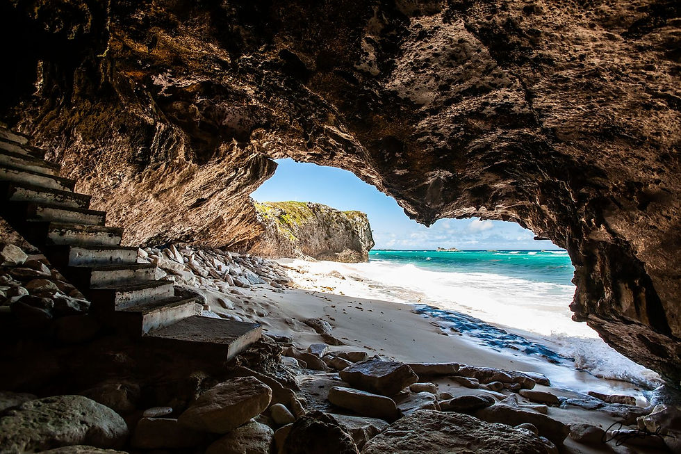 Thumbnail: Limestone sea cave framing turquoise Caribbean water and white sand beach in Turks and Caicos tropical coastal landscape phot