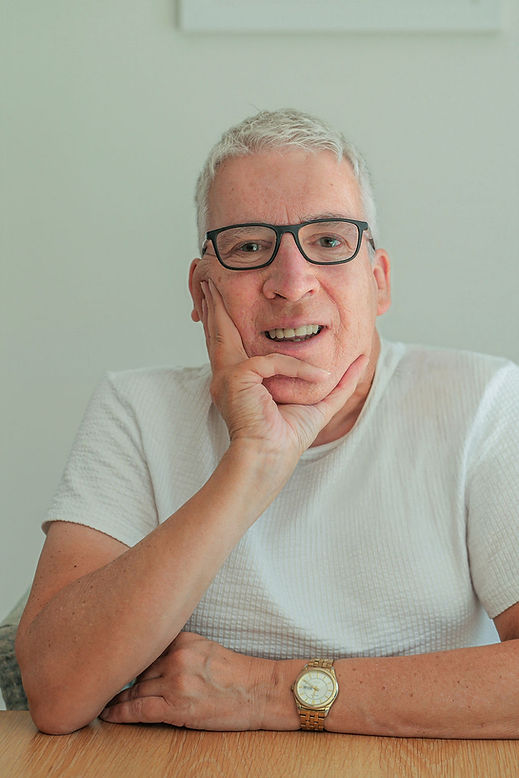 Picture of Ian Wainwright with glasses and grey hair leaning on his hand