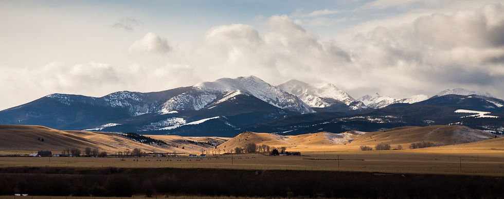 brown field near mountains under white clouds during daytime_edited.jpg