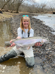 Woman on guided fishing trip at Fish Ohio Outfitters holding Steelhead