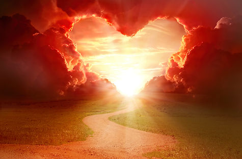 Red heart shaped sky at sunset. Beautiful landscape with road and clouds.Love background