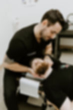 Close-up view of a chiropractor adjusting a patient’s spine
