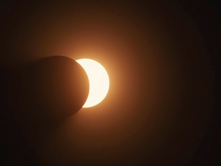 Celestial display during a new moon solar eclipse showcasing the alignment of the sun and moon.