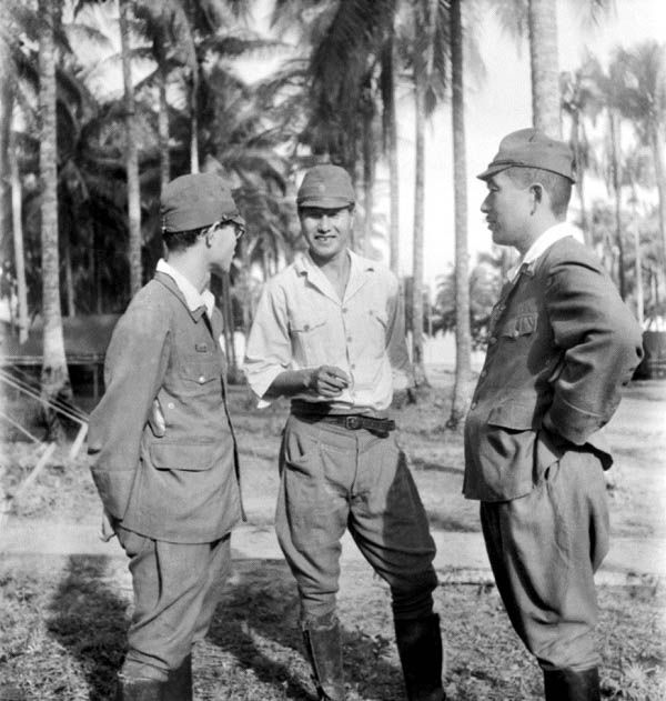 Captain Susumi Hoshijima (centre) conferring with his defence counsel during Labuan War Trials, 1946 (Source: Australian War Memorial)