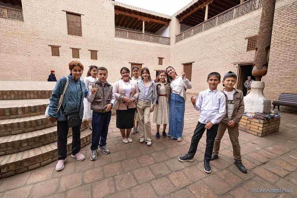 Curious and friendly schoolchildren, along with their teacher, we met at Itchan Kala