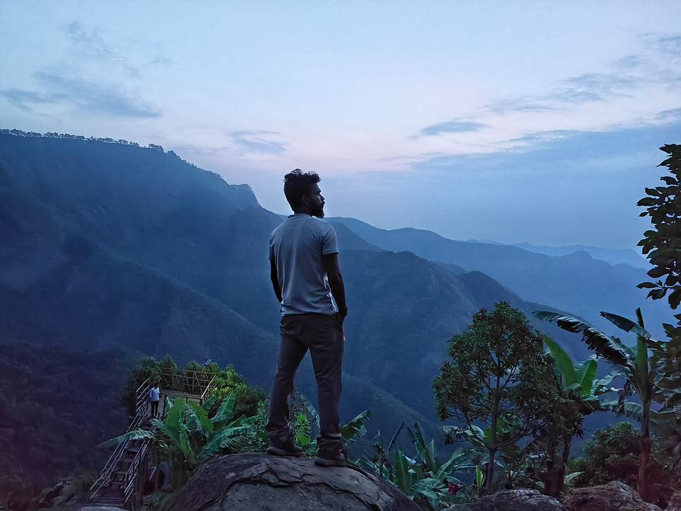 A fellow trekker admiring the mountain view from Eagle Nest campsite