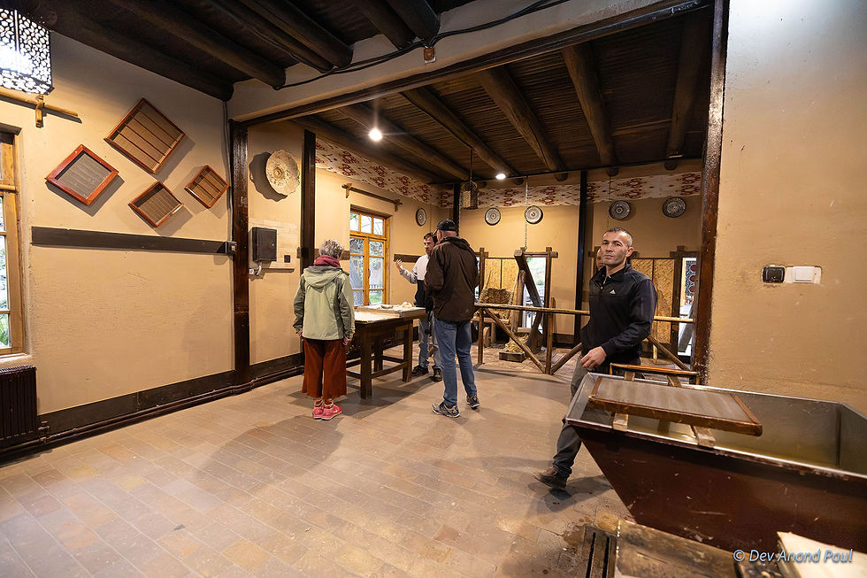 Visitors watching a live demonstration of the traditional Samarkand papermaking process (Konigil Meros Paper Mill)