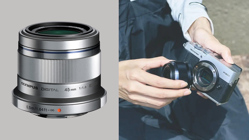 Olympus 45mm lens shown beside hands attaching a lens to an OM SYSTEM PEN camera outdoors.