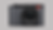 Close-up of a gray Leica camera with textured body. Prominent lens marked "APO-SUMMICRON 1:2/43 ASPH." Red Leica logo. Neutral background.