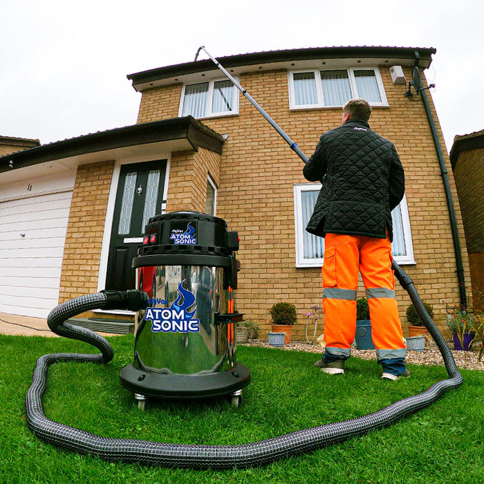 Close-up view of a clean gutter with flowing water
