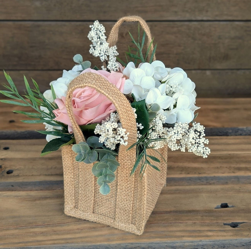 Peaches and cream flower girl basket decorated with peach and ivory flowers