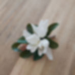 Sweet Magnolia artificial corsage featuring white magnolia petals and green foliage – faux wedding flowers Australia