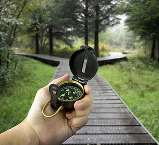 man holding compass with two paths ahead.jpg