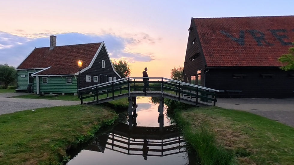 Golden hour at Zaanse Schans from a beautiful wooden bridge with lamps on
