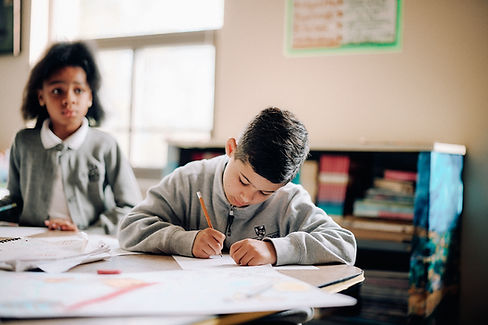 student writing on paper